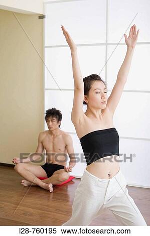 Young couple in yoga attitude, indoors View Large Photo Image Stock Photography - Young couple in yoga attitude, indoors. Fotosearch