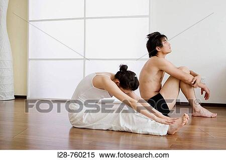 Young couple in yoga attitude, indoors View Large Photo Image Stock Photography - Young couple in yoga attitude, indoors. Fotosearch