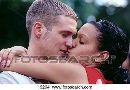 Picture - Young couple kissing. Fotosearch