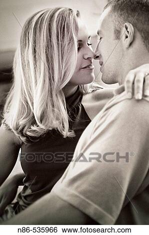 Stock Photograph - Young couple kissing. Fotosearch