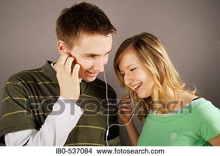 Young couple listening to music View Large Photo Image Picture - Young couple listening to music. Fotosearch