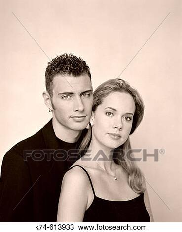 Young couple looking at camera View Large Photo Image Stock Image - Young couple looking at camera. Fotosearch