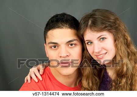 Picture - Young couple looking at the camera. Fotosearch