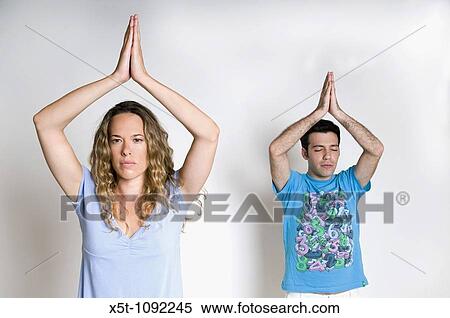 young Couple Meditating on white background Model releases available View Large Photo Image Stock Photography - young Couple Meditating on white background Model releases available. Fotosearch