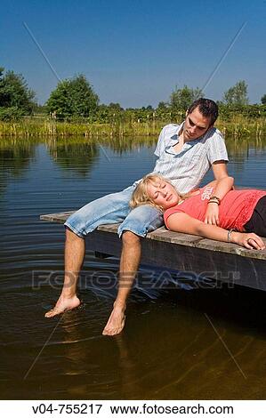 Young couple on a footbridge at a lake View Large Photo Image Stock Photo - Young couple on a footbridge at a lake. Fotosearch