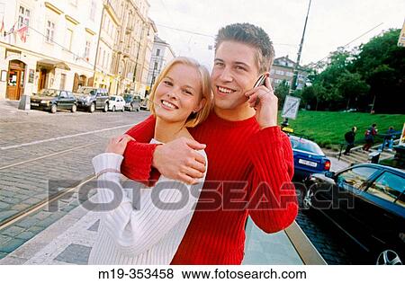 young couple on cellular View Large Photo Image Stock Photo - young couple on cellular. Fotosearch