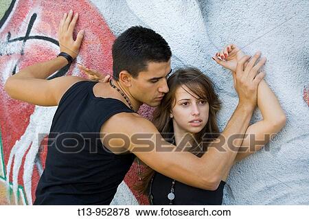Young couple on colorful wall View Large Photo Image Stock Photo - Young couple on colorful wall. Fotosearch