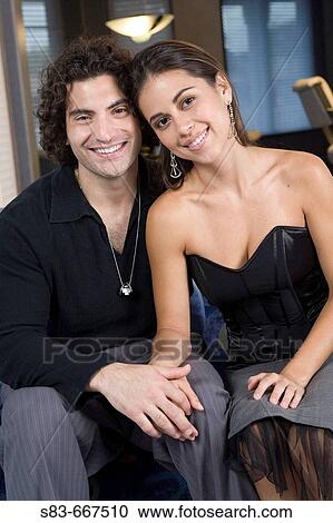 Young couple on couch in club. View Large Photo Image Stock Image - Young couple on couch in club.. Fotosearch