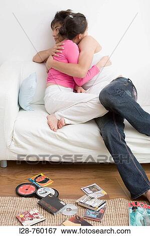 Young couple on sofa View Large Photo Image Stock Photo - Young couple on sofa. Fotosearch