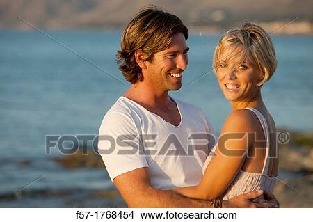 Young couple on the beach View Large Photo Image Picture - Young couple on the beach. Fotosearch