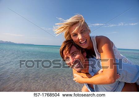 Young couple on the beach View Large Photo Image Picture - Young couple on the beach. Fotosearch