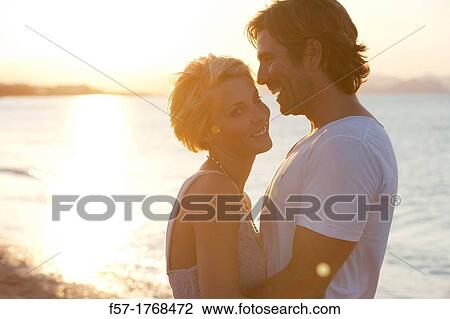 Young couple on the beach View Large Photo Image Stock Image - Young couple on the beach. Fotosearch