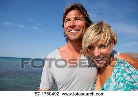 Young couple on the beach View Large Photo Image Stock Image - Young couple on the beach. Fotosearch