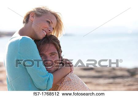 Young couple on the beach View Large Photo Image Stock Image - Young couple on the beach. Fotosearch