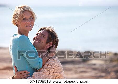 Stock Image - Young couple on the beach. Fotosearch