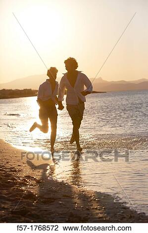 Young couple on the beach View Large Photo Image Stock Image - Young couple on the beach. Fotosearch