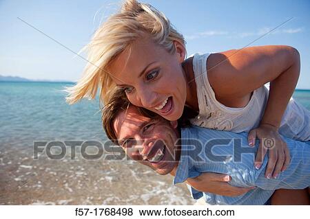 Stock Photo - Young couple on the beach. Fotosearch