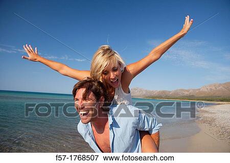 Stock Photo - Young couple on the beach. Fotosearch