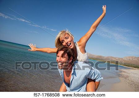 Stock Photo - Young couple on the beach. Fotosearch