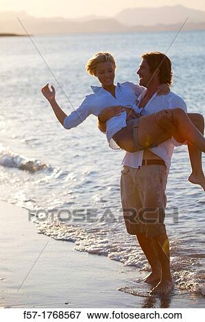 Young couple on the beach View Large Photo Image Stock Photo - Young couple on the beach. Fotosearch