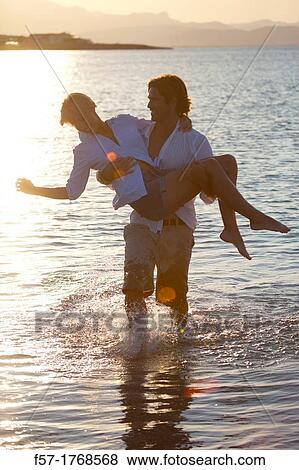 Young couple on the beach View Large Photo Image Stock Photo - Young couple on the beach. Fotosearch