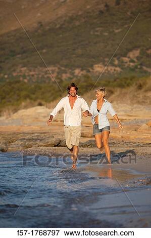 Young couple on the beach View Large Photo Image Stock Photo - Young couple on the beach. Fotosearch