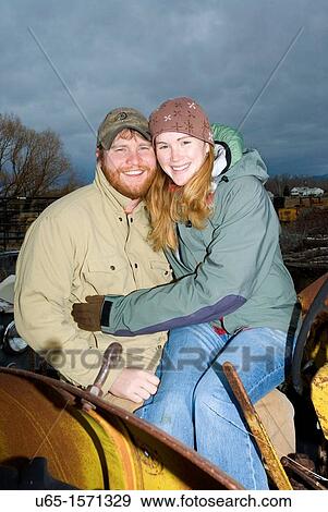 Stock Photo - Young couple on tractor. Fotosearch