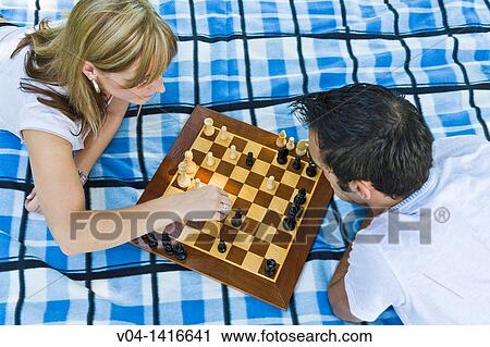 Young couple playing chess in the garden, Germany, Europe View Large Photo Image Stock Image - Young couple playing chess in the garden, Germany, Europe. Fotosearch