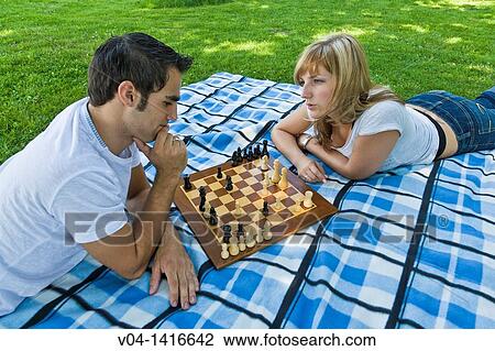 Young couple playing chess in the garden, Germany, Europe View Large Photo Image Stock Image - Young couple playing chess in the garden, Germany, Europe. Fotosearch