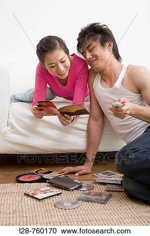 Young Couple reading dvd cover View Large Photo Image Stock Image - Young Couple reading dvd cover. Fotosearch