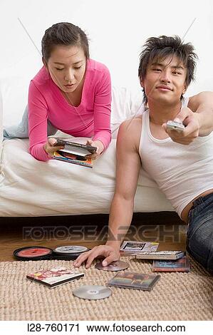 Young Couple reading dvd cover View Large Photo Image Stock Image - Young Couple reading dvd cover. Fotosearch