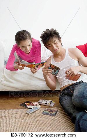 Young Couple reading dvd cover View Large Photo Image Stock Image - Young Couple reading dvd cover. Fotosearch