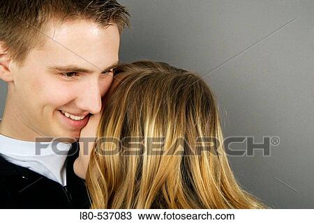 Young couple sharing an intimate moment View Large Photo Image Stock Image - Young couple sharing an intimate moment. Fotosearch