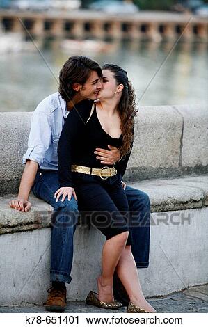 Young couple sitting in Barrio Triana by the Guadalquivir river, Seville, Spain. View Large Photo Image Stock Image - Young couple sitting in Barrio Triana by the Guadalquivir river, Seville, Spain.. Fotosearch