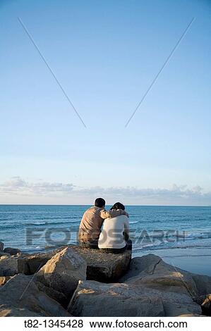 Young couple sitting in front of the sea, Tangier, Morocco, Northern Africa View Large Photo Image Stock Photo - Young couple sitting in front of the sea, Tangier, Morocco, Northern Africa. Fotosearch