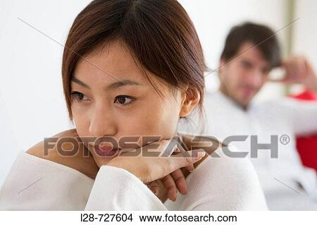 Picture - Young Couple sitting on sofa. Fotosearch