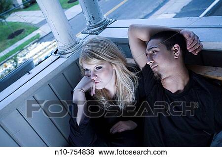 Young couple sitting on their porch. View Large Photo Image Stock Photo - Young couple sitting on their porch.. Fotosearch