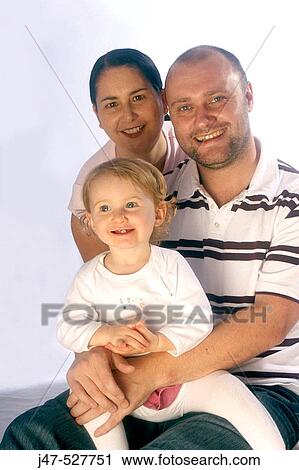 young couple sitting with a 3 year old girl, studio View Large Photo Image Stock Image - young couple sitting with a 3 year old girl, studio. Fotosearch