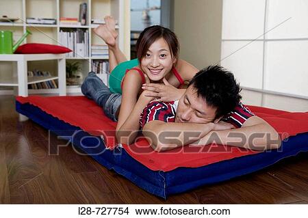 Picture - Young couple sleeping on bed, close-up. Fotosearch