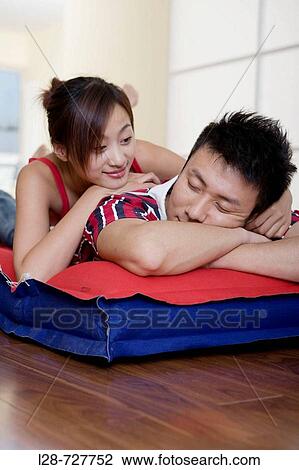Young couple sleeping on bed, close-up View Large Photo Image Stock Image - Young couple sleeping on bed, close-up. Fotosearch