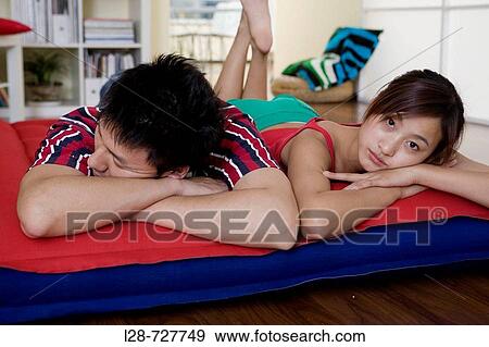 Young couple sleeping on bed, close-up View Large Photo Image Stock Photo - Young couple sleeping on bed, close-up. Fotosearch
