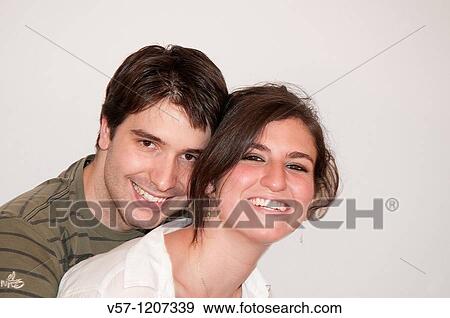 Stock Photo - Young couple smiling and looking at the camera. Fotosearch