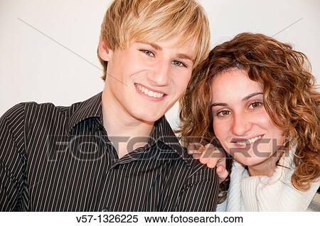 Young couple smiling and looking at the camera. Close view. View Large Photo Image Stock Photography - Young couple smiling and looking at the camera. Close view.. Fotosearch