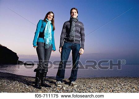 Young couple standing on the beach View Large Photo Image Stock Photography - Young couple standing on the beach. Fotosearch