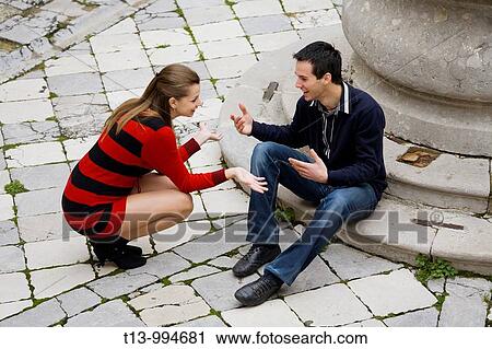 Young couple talk on the street View Large Photo Image Stock Image - Young couple talk on the street. Fotosearch
