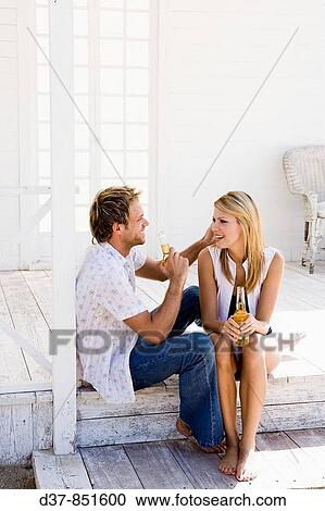 Young couple talking at home View Large Photo Image Stock Image - Young couple talking at home. Fotosearch