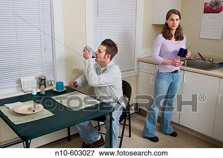 Young couple together in their kitchen. View Large Photo Image Stock Photo - Young couple together in their kitchen.. Fotosearch
