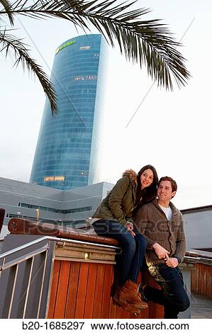 Young couple, Tourists, Iberdrola Tower, Padre Arrupe Bridge, Abandoibarra, Bilbao, Bizkaia, Basque Country, Spain View Large Photo Image Stock Photo - Young couple, Tourists, Iberdrola Tower, Padre Arrupe Bridge, Abandoibarra, Bilbao, Bizkaia, Basque Country, Spain. Fotosearch