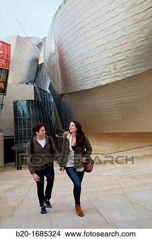 Young couple visiting the city, Guggenheim Museum, Abandoibarra, Bilbao, Bizkaia, Basque Country, Spain View Large Photo Image Picture - Young couple visiting the city, Guggenheim Museum, Abandoibarra, Bilbao, Bizkaia, Basque Country, Spain. Fotosearch