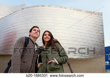 Young couple visiting the city, Guggenheim Museum, Abandoibarra, Bilbao, Bizkaia, Basque Country, Spain View Large Photo Image Stock Image - Young couple visiting the city, Guggenheim Museum, Abandoibarra, Bilbao, Bizkaia, Basque Country, Spain. Fotosearch